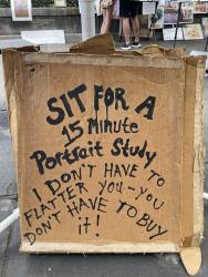 Cardboard sign about 15 minute portraits